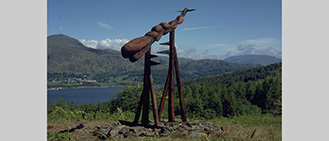 Title: To Fuel a Dream. Grizedale Forest, Cumbria. Situated in the Forest between Lake Windemere and Lake Coniston. 1989 Wood sculpture